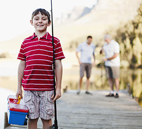 Boy with fishing pole and tackle box