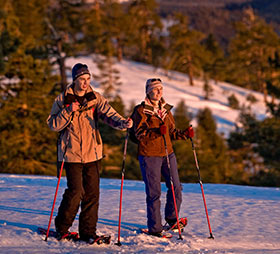 Couple snowshoeing on Tempo Dome near Badger Pass
