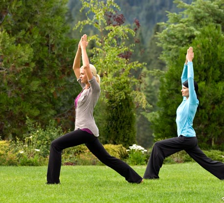 Women in warrior pose on Counties lawn