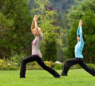 Women in warrior pose on Counties lawn