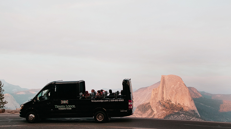 Tenaya Tour van on the way to Glacier Point with Half Dome in the background