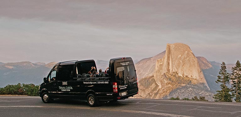 Tenaya Tour van on the way to Glacier Point with Half Dome in the background