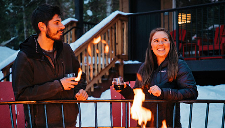 Tenaya Lodge Explorer Cabin guests enjoying a glass of wine by the outdoor fire pits