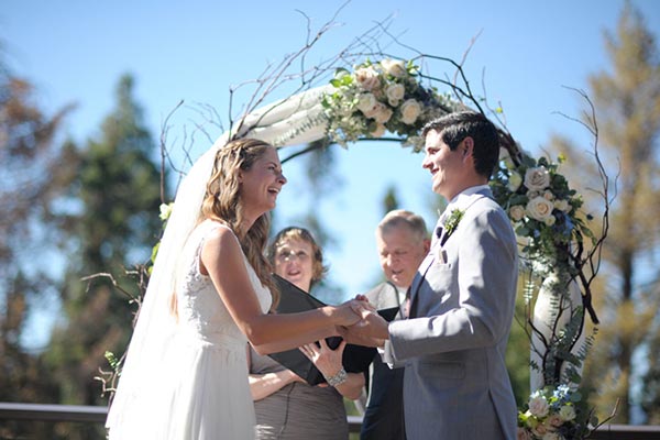 Krystal Preciado wedding photography: photo of couple exchanging vows at Tenaya Lodge